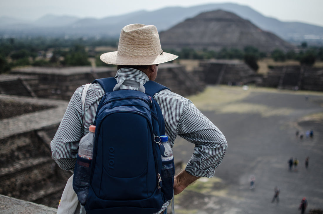 Man climbing the pyramids of Teotihuacan